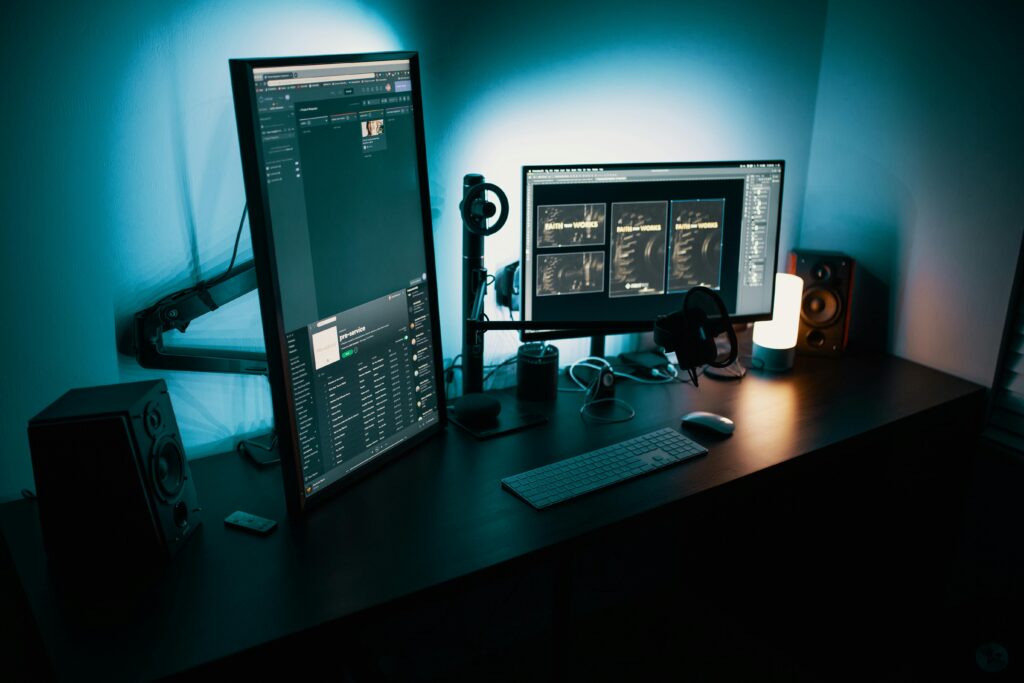 Home A contemporary office desk featuring a dual monitor setup with stylish lighting, ideal for tech enthusiasts.
