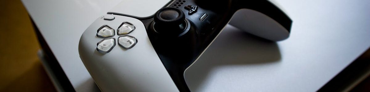 Detailed shot of a PlayStation 5 controller resting on the console, highlighting modern gaming design.